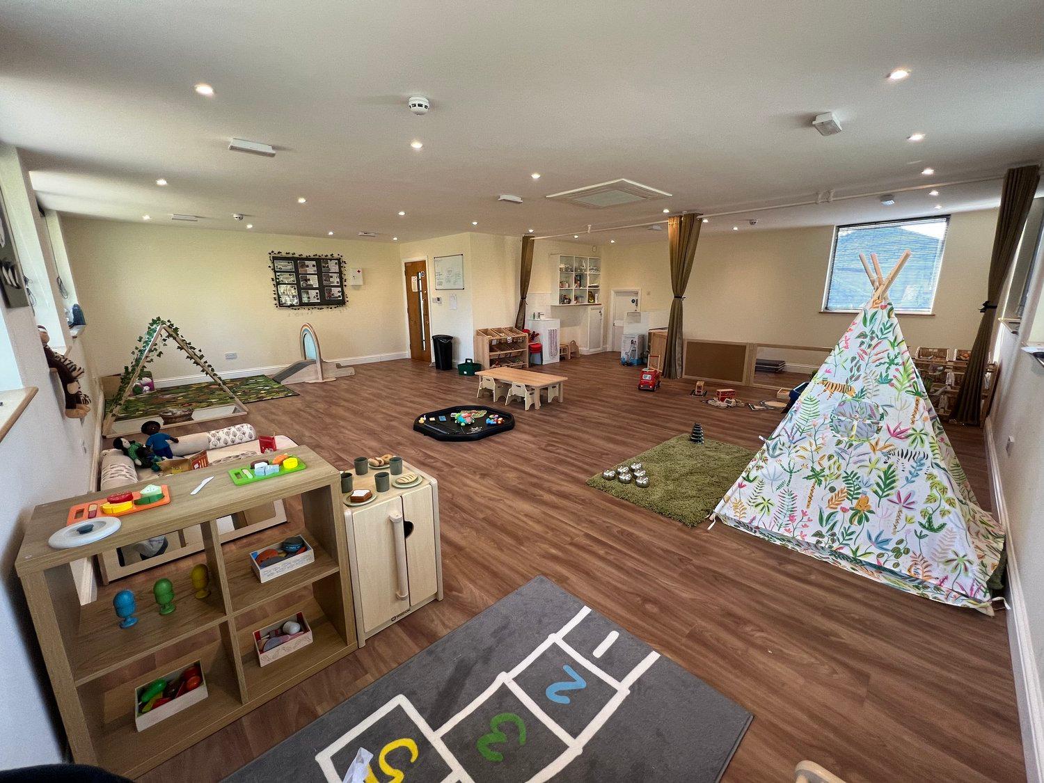 An inclusive, spacious nursery room with varied play and sensory areas