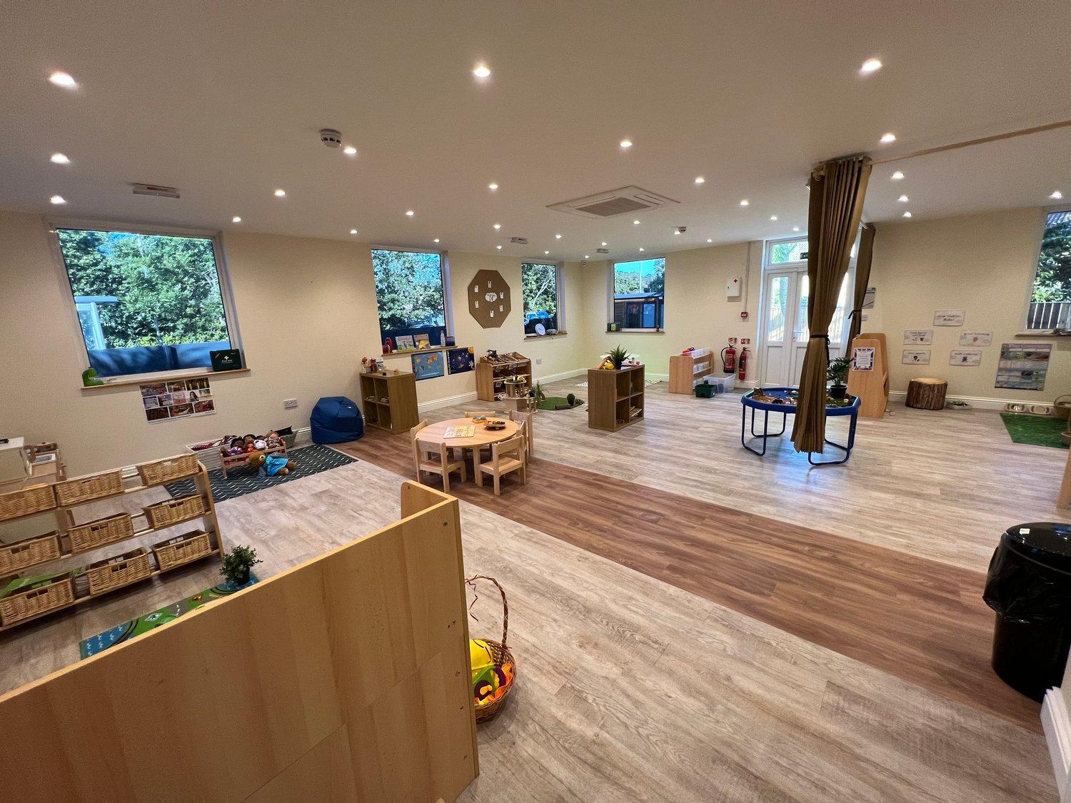 A light-filled nursery room with learning areas prepared for the day